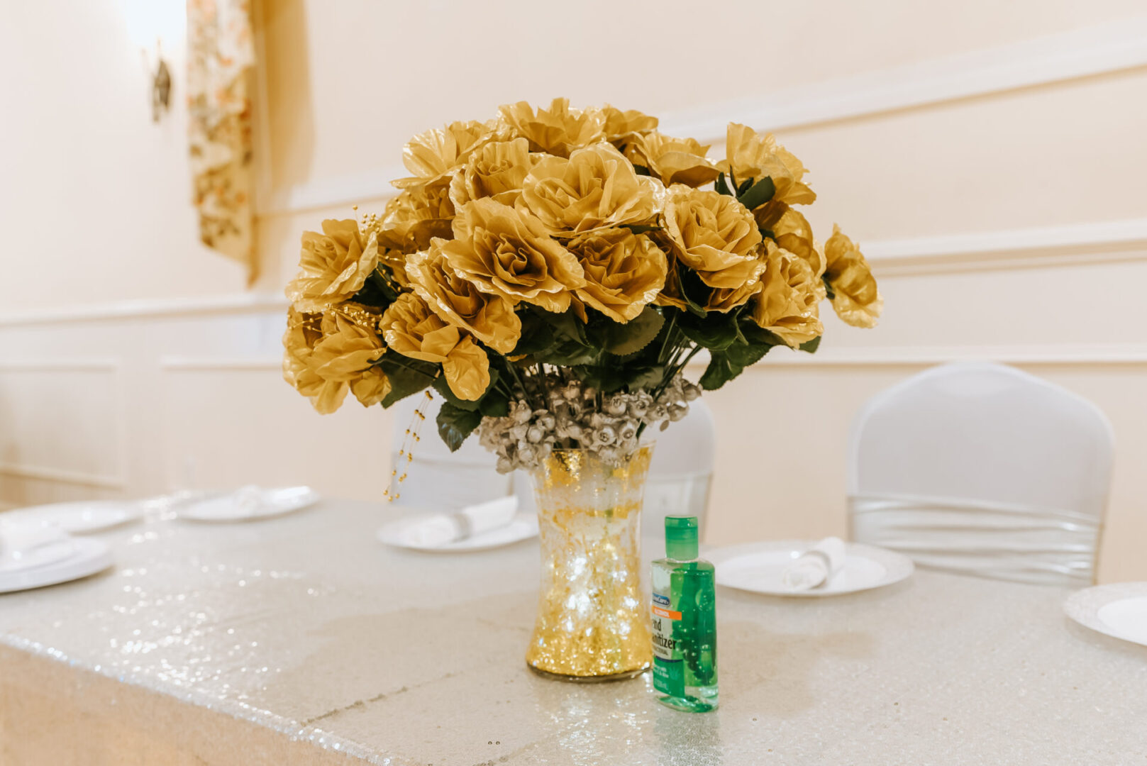 Golden roses in a vase on a table